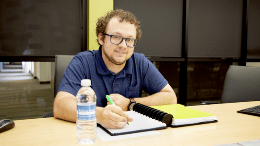 man writing in a notebook